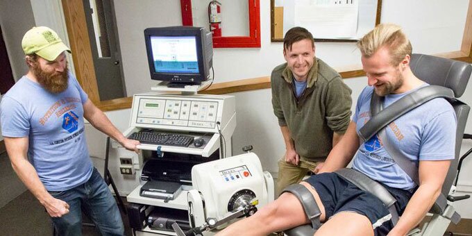 Student getting his leg examined on a machine
