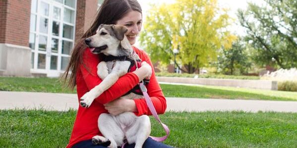 Student holding a dog